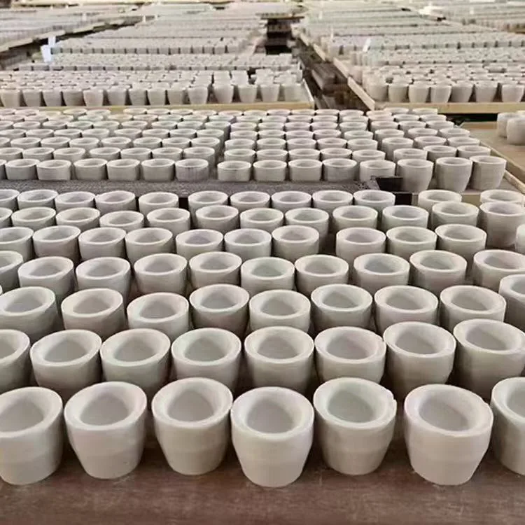 Fire assay cupels arranged on a tray