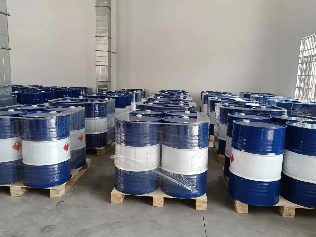 Palletised 200-litre steel drums, shrink-wrapped, carrying Class 3 flammable-liquid labels